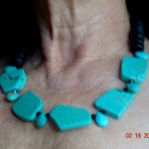 Stunning statement necklace w/turquoise-look stones framed by black disc beads.